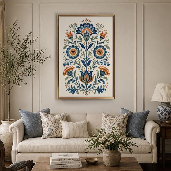 Folk art floral illustration with symmetrical blue and orange daisy and carnation, displayed in a warm light living room